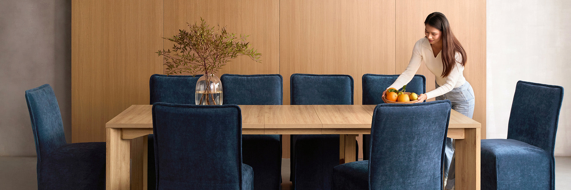 Lifestyle banner image of a oak extendable dining table with washable slipcover dining chairs in sumi blue fabric, styled in a real home setting, highlighting a 30-day risk-free trial.