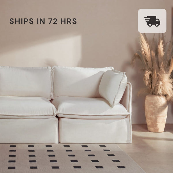 Lifestyle image of a 2-seater modular sofa in white fabric styled in a modern living room.