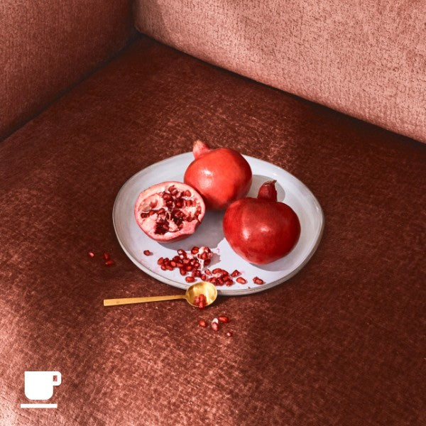 Close-up image of plate of pomegranate fruit on a modular sofa fabric highlighting stain-resistant and liquid-resistant performance for everyday living.