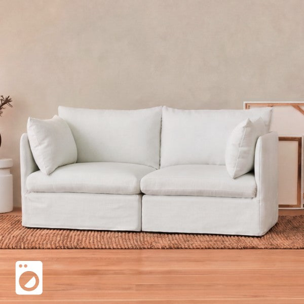 Lifestyle image of a loveseat sofa without slipcovers, highlighting the washable duvet-style cover system.