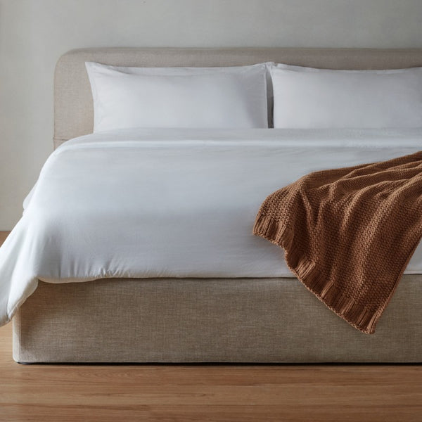 washable slipcover bed frame in oat fabric highlighting sustainable construction and responsibly sourced down materials.