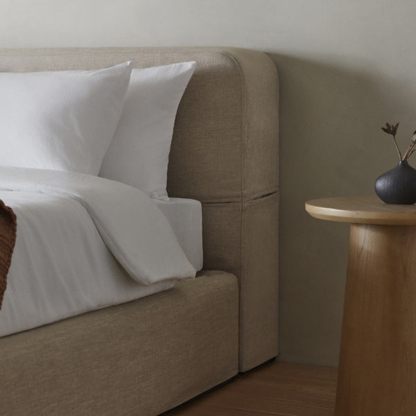 Close-up of Oat fabric bed frame highlighting sustainable materials and carbon-neutral shipping.